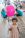 A photograph of a little girl with a pink balloon