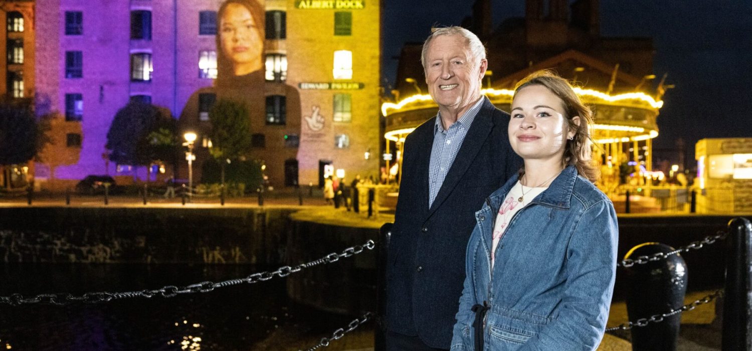 A photograph of Chris Tarrant and Vladyslava Zhmuro at a portrait unveiling at Liverpool's Royal Albert Dock.