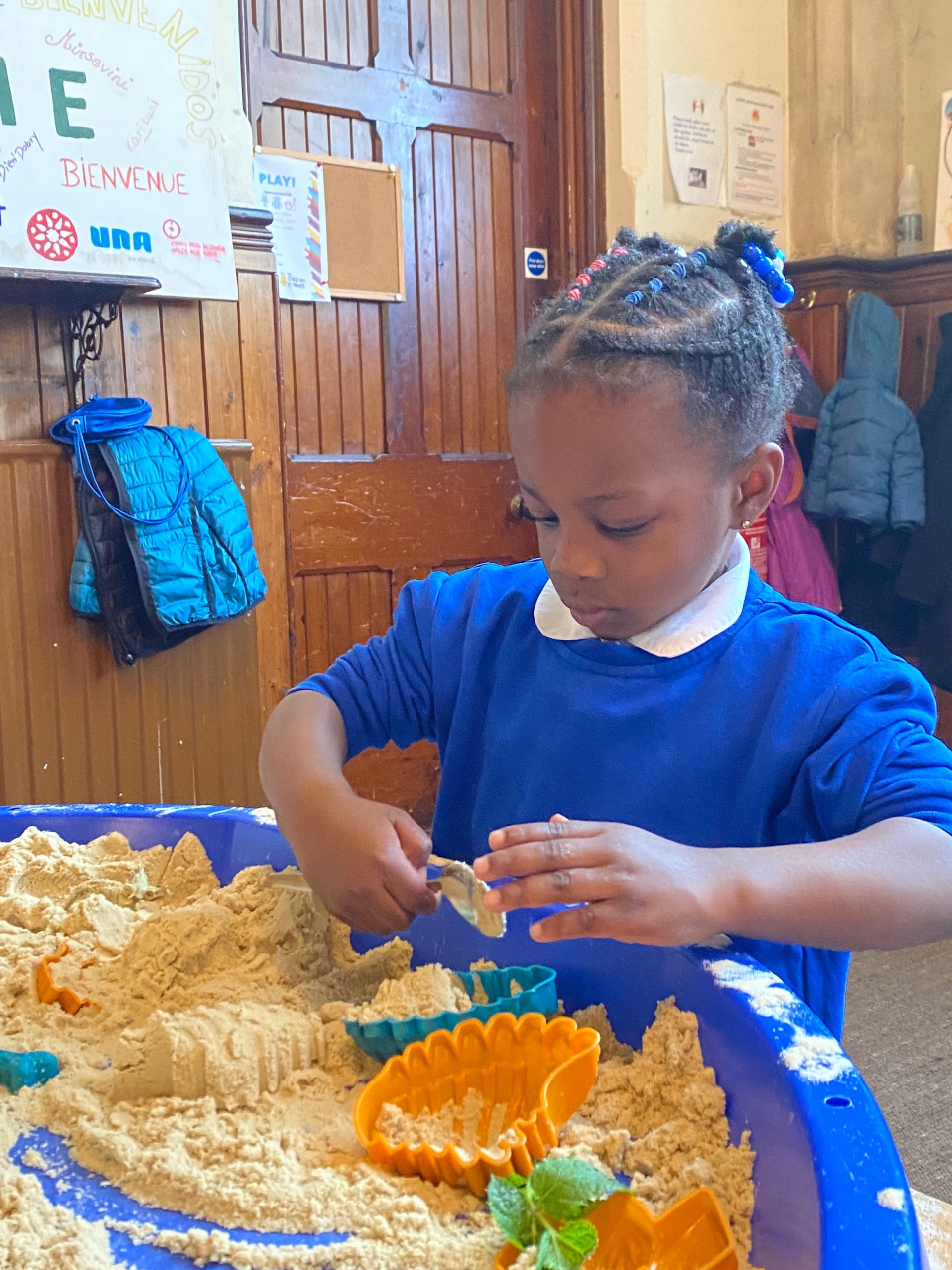 MicrosoftTeams-image (15) A photograph of a little girl playing in a sand box as part of the Safe Play Spaces project.