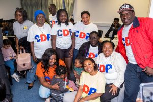 A photograph of a group of people from the Congo Development Project at an event for Mental Health Day and Black History Month.
