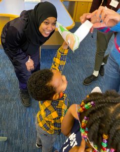 A photograph of our volunteer Tawhida playing with kids at the Safe Play Spaces Project.