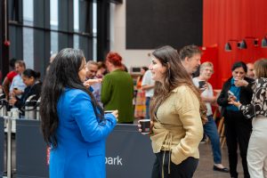 Two women talking at a Welsh Refugee Council event.