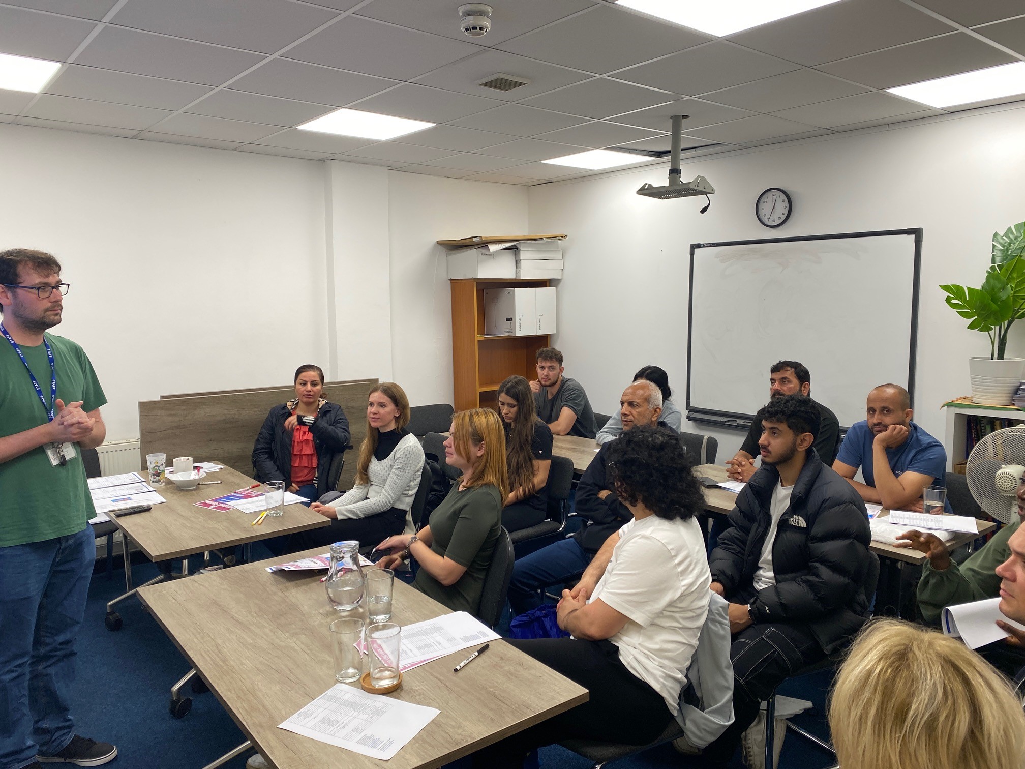 Housing form Man presenting to a room full of people.