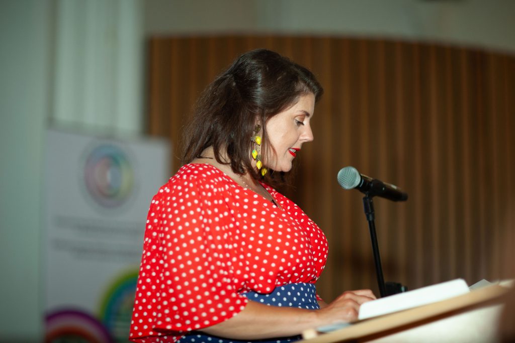 Woman speaking into microphone. 