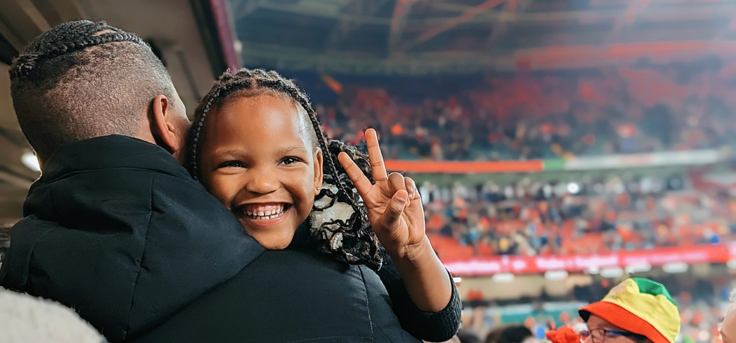 A sanctuary seeking child smiles at the Principality Stadium.