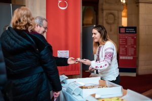 Woman registering visitors at an event.