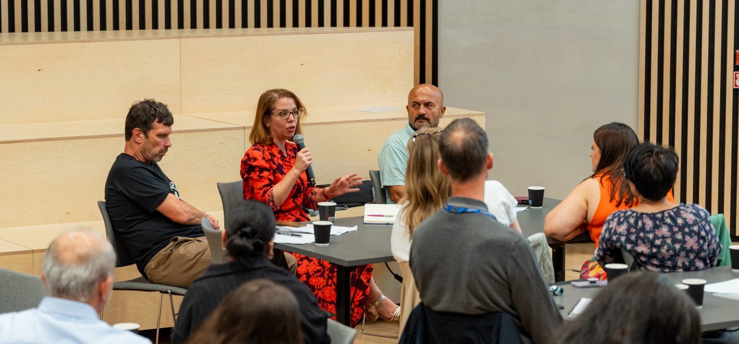 Andrea holding the mic talking to the Welsh Refugee Council.