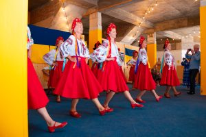 Women dancing together in traditional Ukranian dress.