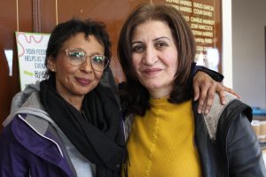 Two women hugging at a Welsh Refugee Council workshop. 