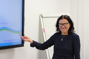 Employability Officer at the Welsh Refugee Council office presenting in a meeting room. 