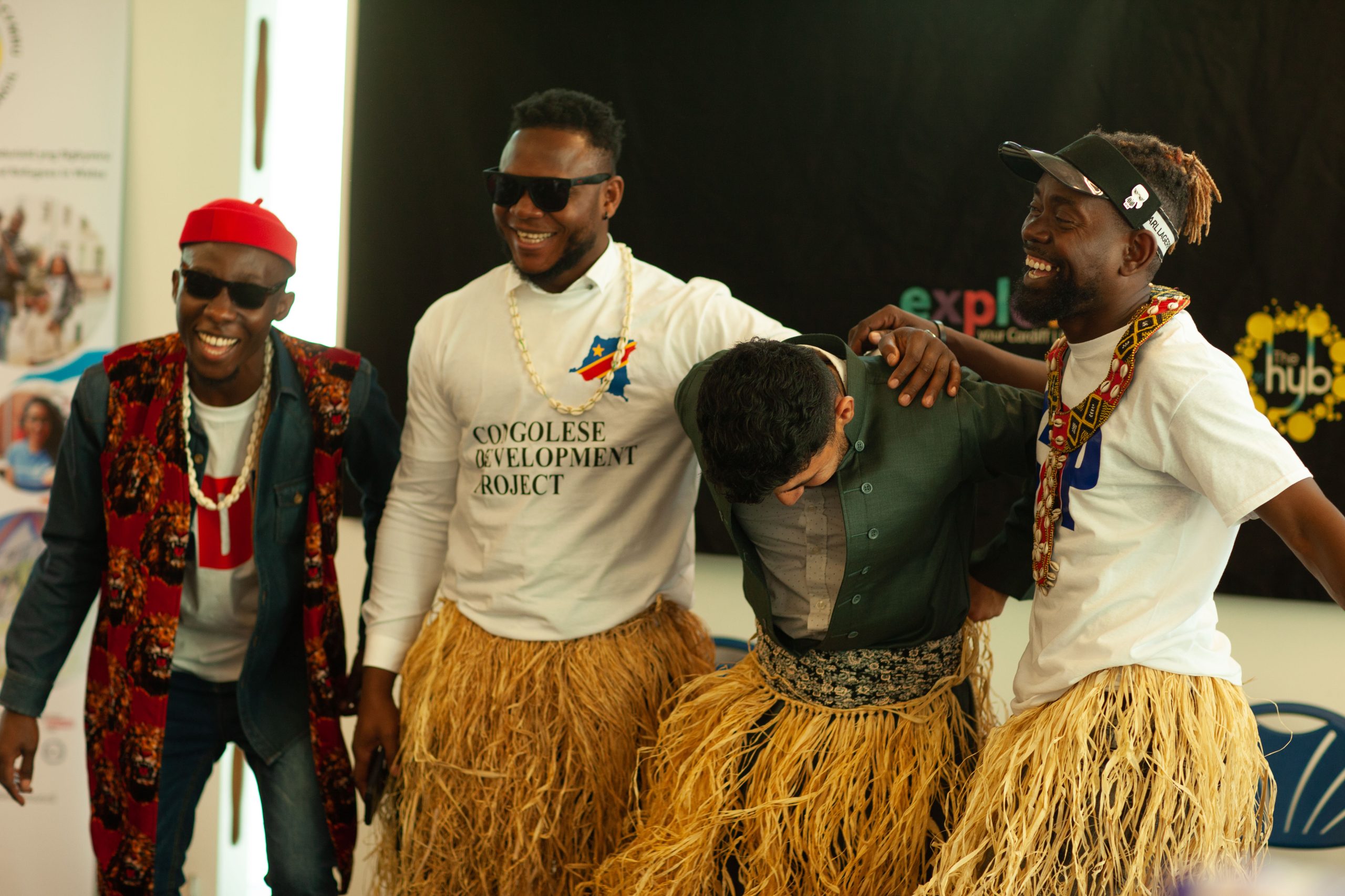 Men hugging and smiling at a Refugee Week celebration event.