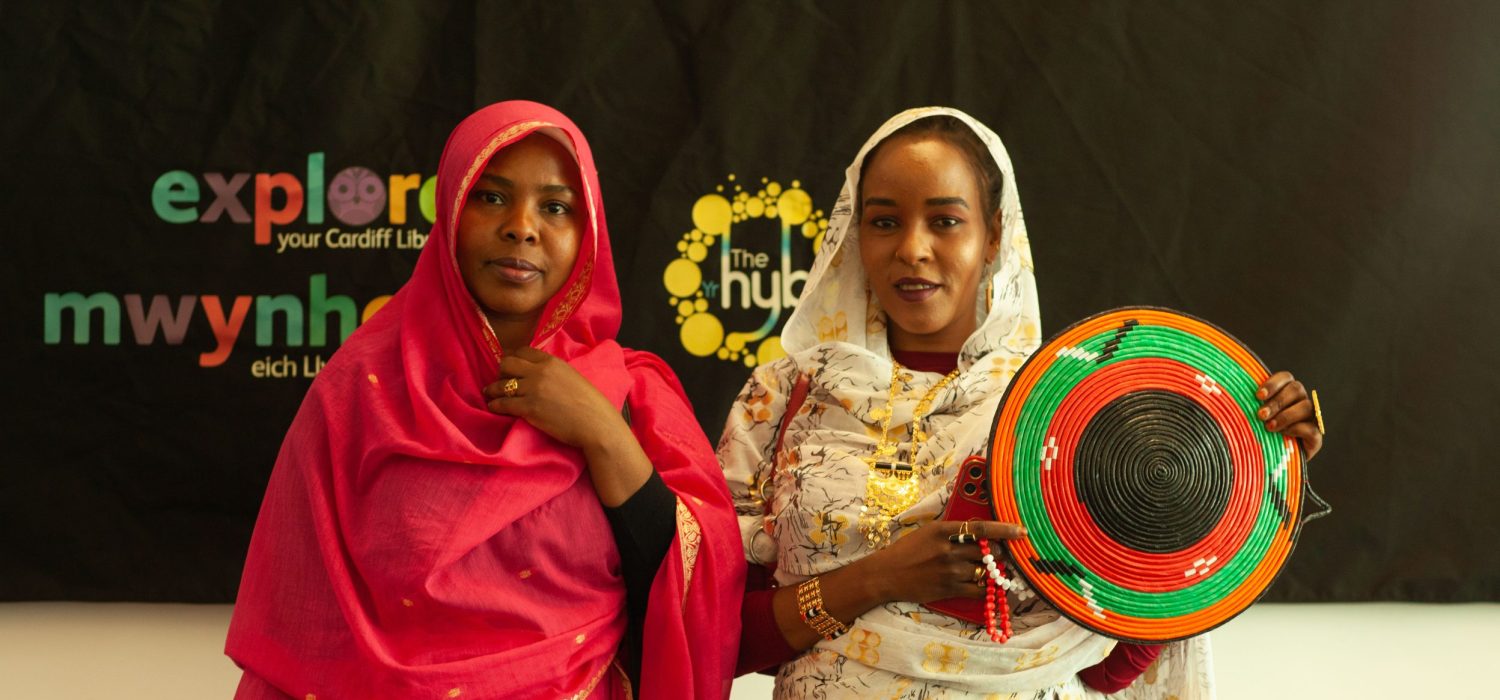 Two women celebrating a Refugee Week event at Cardiff Library.