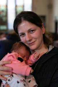 Woman holding her bab y at a Welsh Refugee Council Play Project session. 