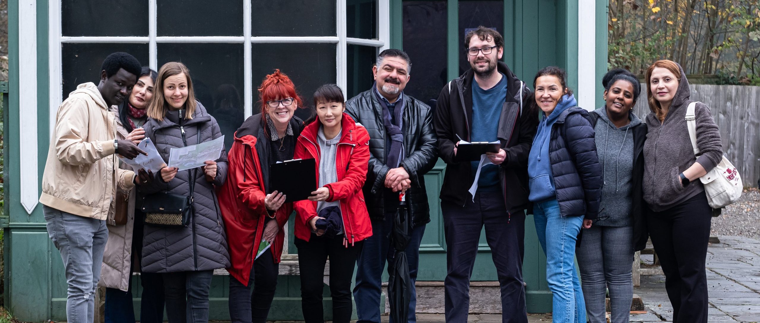 Welsh Refugee Council staff outside working as a team.
