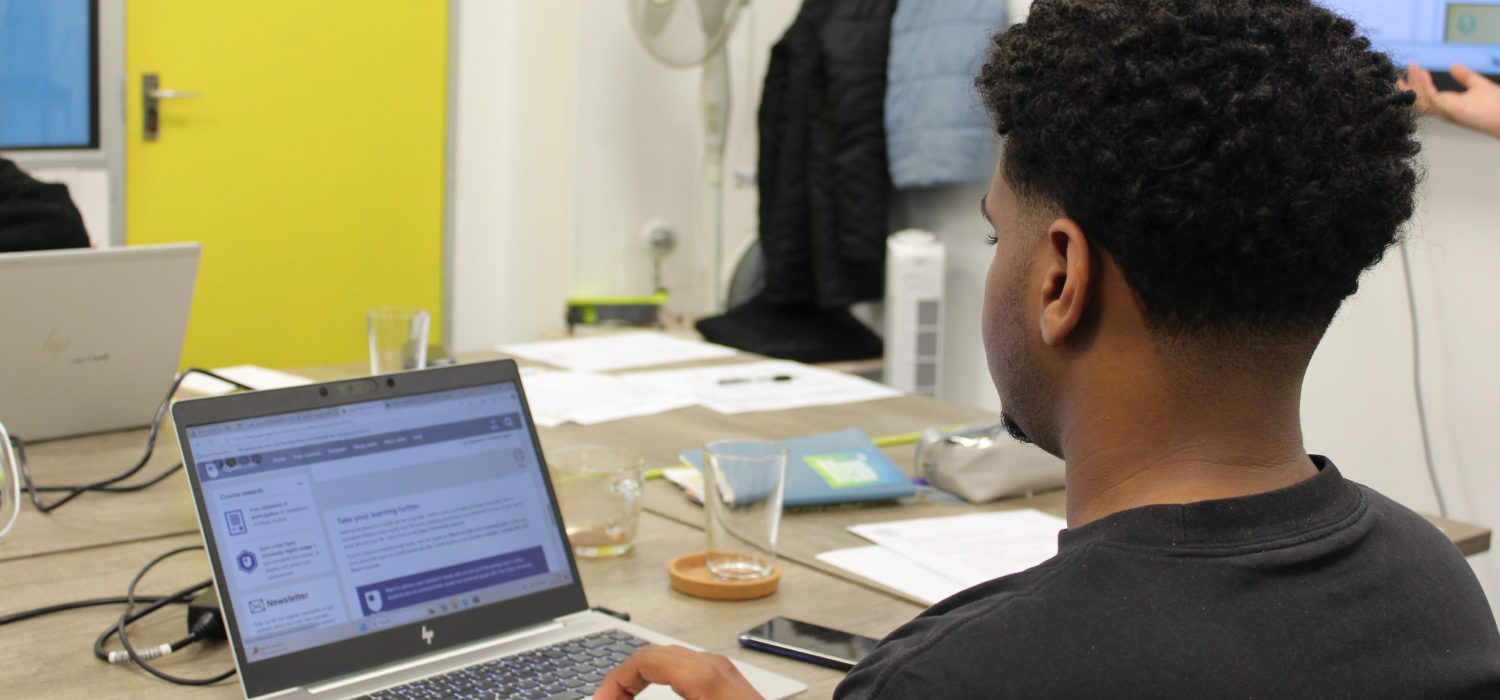Young man working at a laptop.
