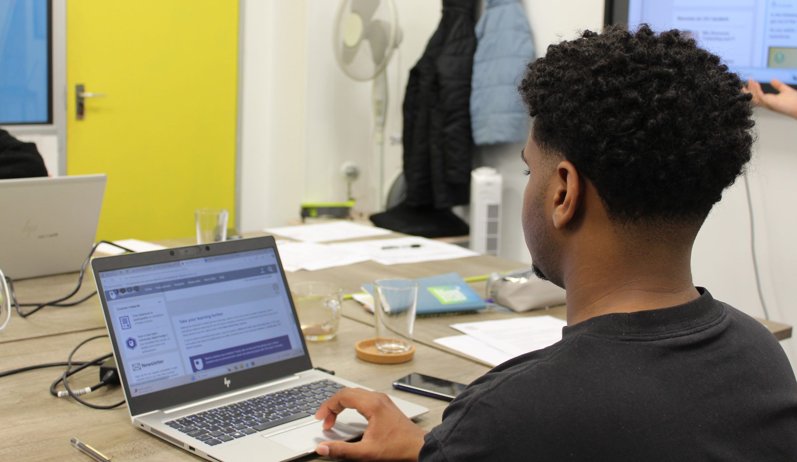 Young man working at a laptop.