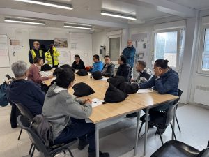 Education and employability team sitting together at a site visit open day. 