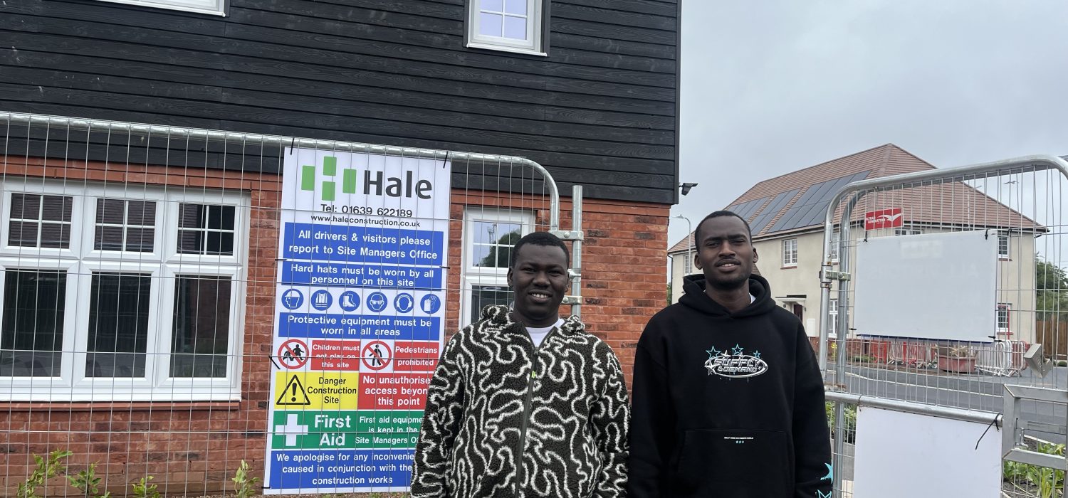 Two smiling men at a Welsh Refugee Council employability session.