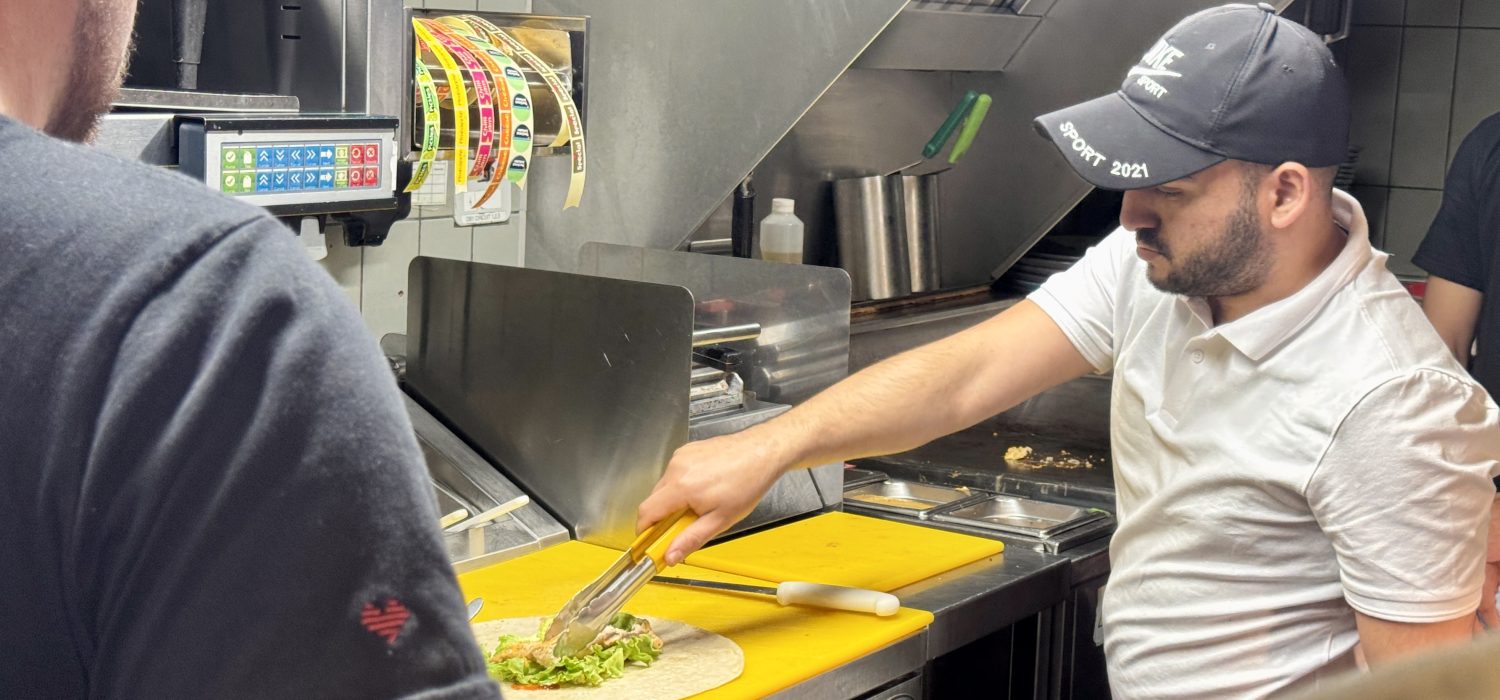 Man cooking in Nandos kitchen.