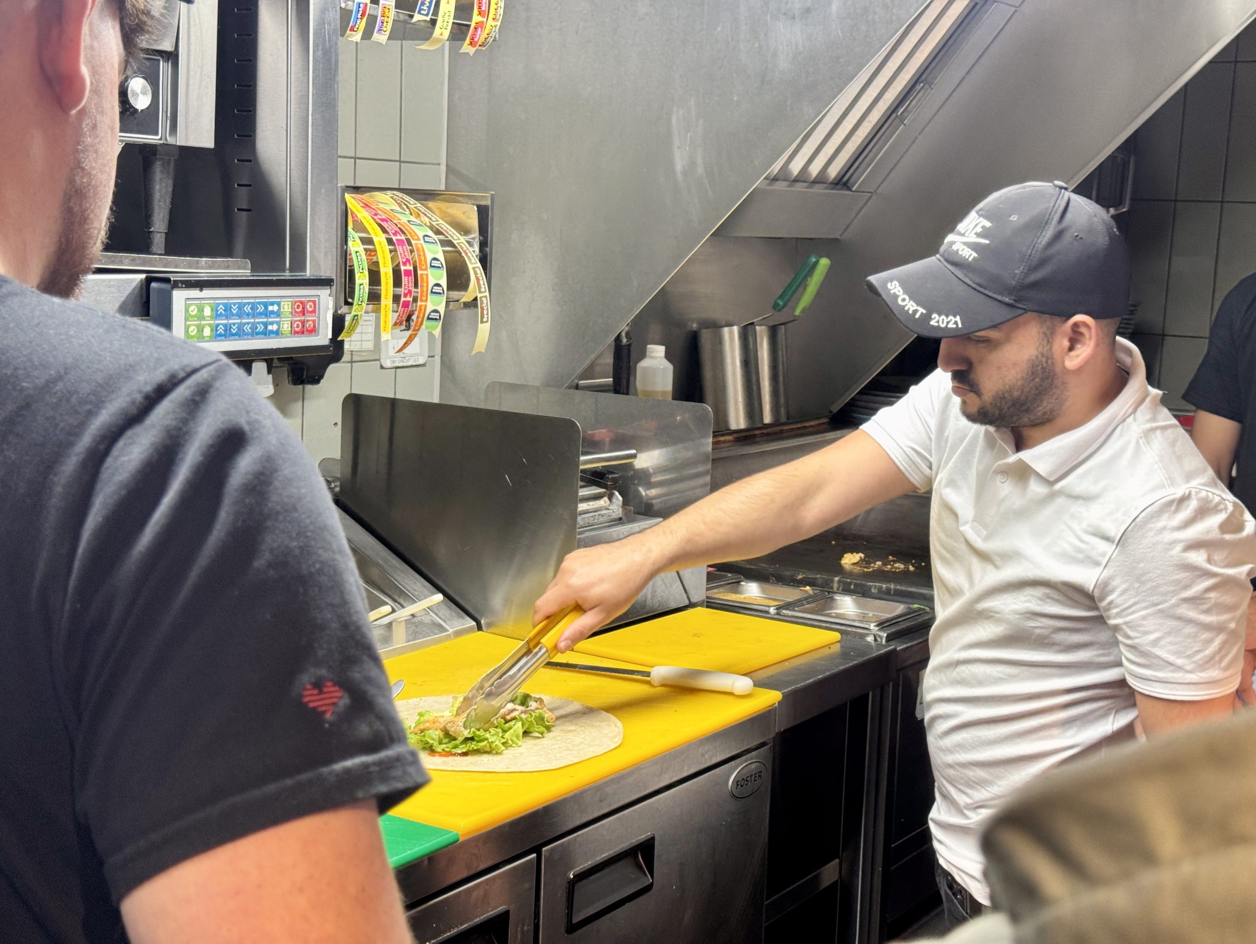 Man cooking in Nandos kitchen.