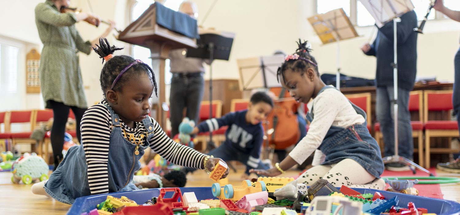 Two girls playing with toys at a Play Project session for sanctuary seeking children.