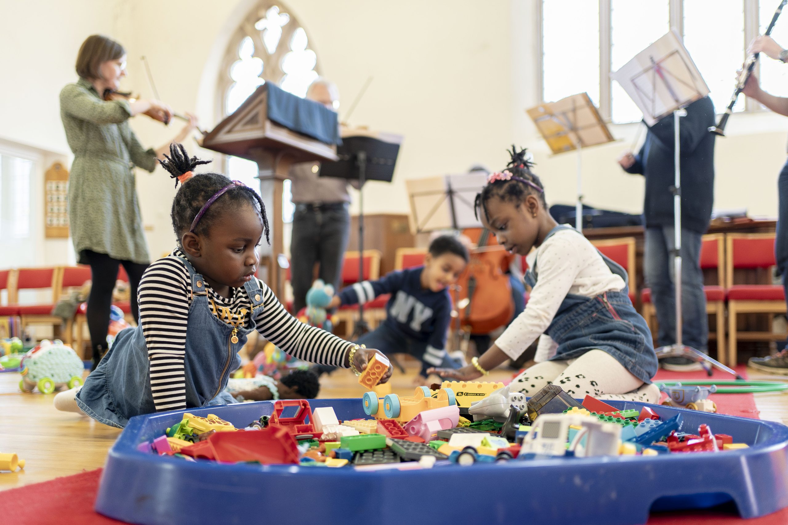 Two girls playing with toys at a Play Project session for sanctuary seeking children.