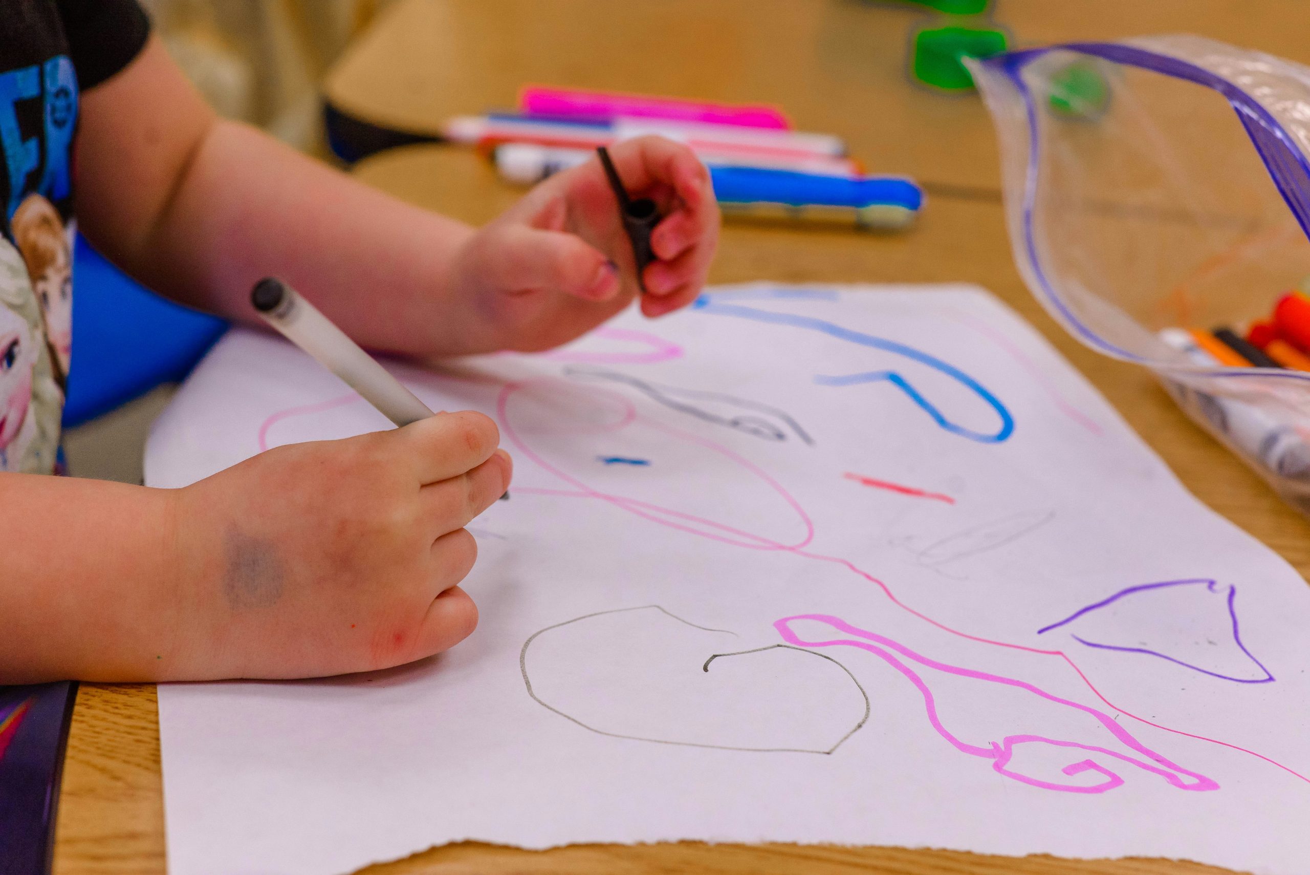 Child's hands drawing.