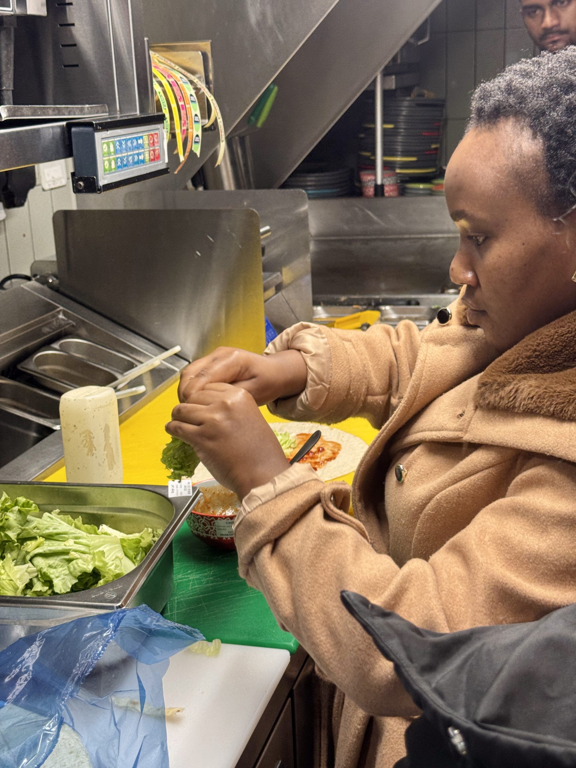 Woman making food at a hospitality day visit with Welsh Refugee Council.