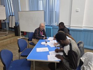 People sitting around a desk writing